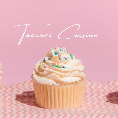 A vanilla cupcake topped with swirled buttercream and rainbow sprinkles